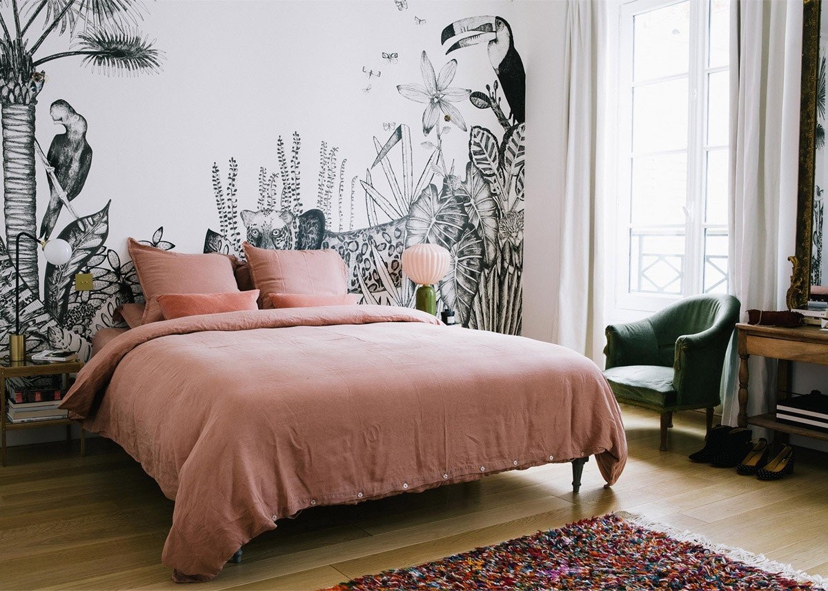 pink-linen-sheets-and-a-black-and-white-jungle-mural-in-the-bedroom-a-happy-chic-parisian-apartment-tour-via-coco-kelley.jpg