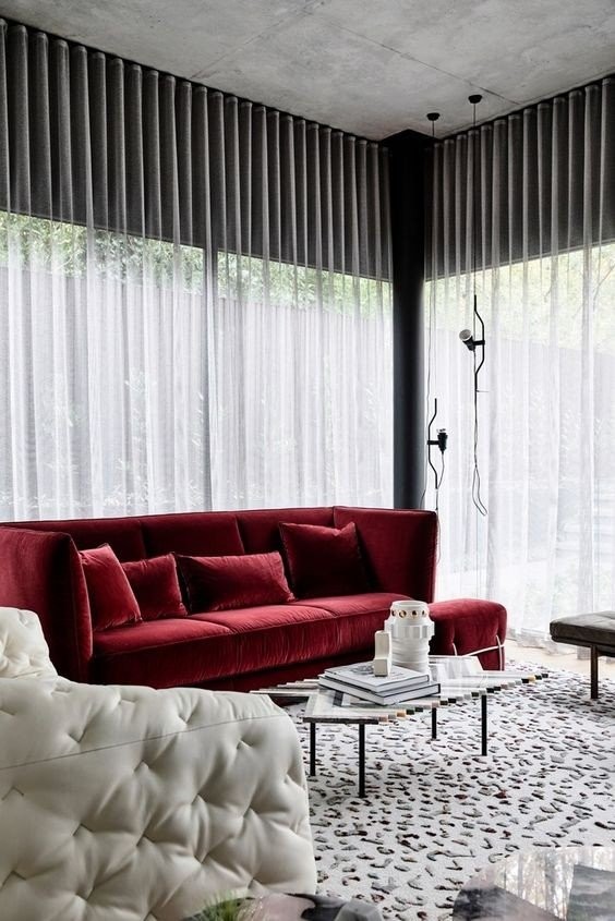 a-cool-monochromatic-space-with-black-and-white-furniture-a-printed-and-textural-rug-and-a-bold-red-sofa-for-a-touch-of-color.jpg