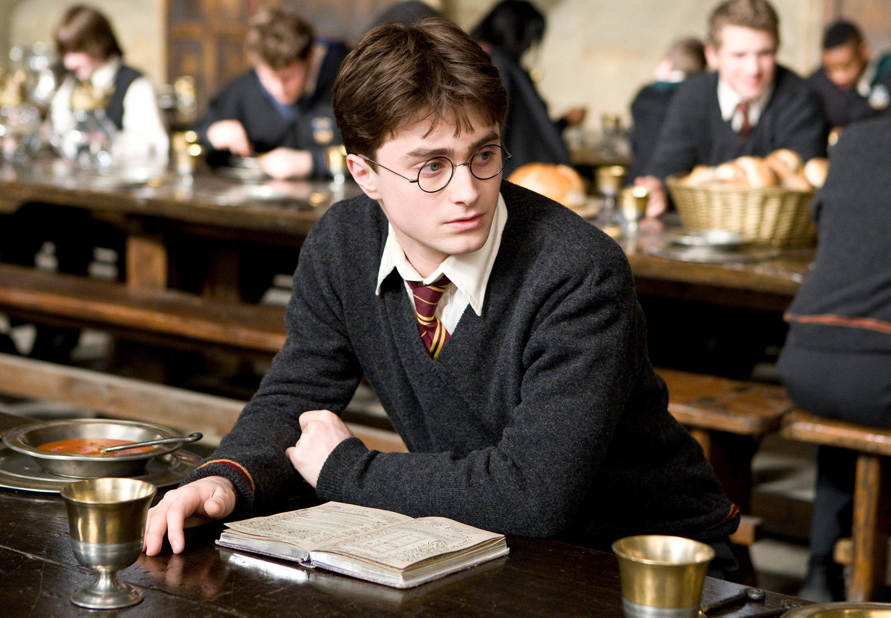 hp-f6-harry-at-great-hall-table-web-fact-file-image.jpg