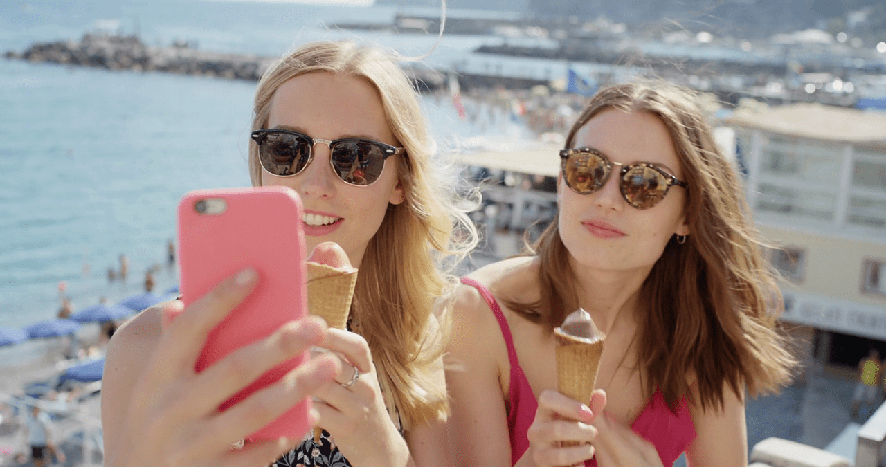 videoblocks-young-women-taking-selfie-photo-eating-ice-cream-on-beach-best-friends-sharing-italian-gelato-outdoors-in-summer-sunshine-girls-enjoying-european-vacation-travel-adventure-amalfi-coast-italy-sil37qwcqx-thumbnail-full01.png