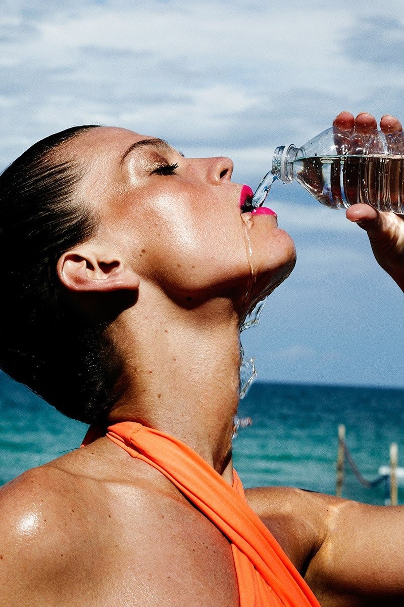 woman-drinking-water-sports-bottle-ocean-fitness.jpg