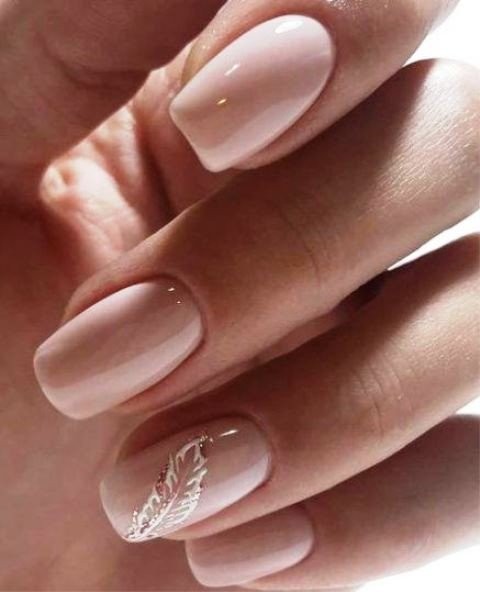 29-shiny-blush-nails-with-an-accent-on-the-ring-finger-with-a-white-and-gold-glitter-feather-for-a-bride.jpg