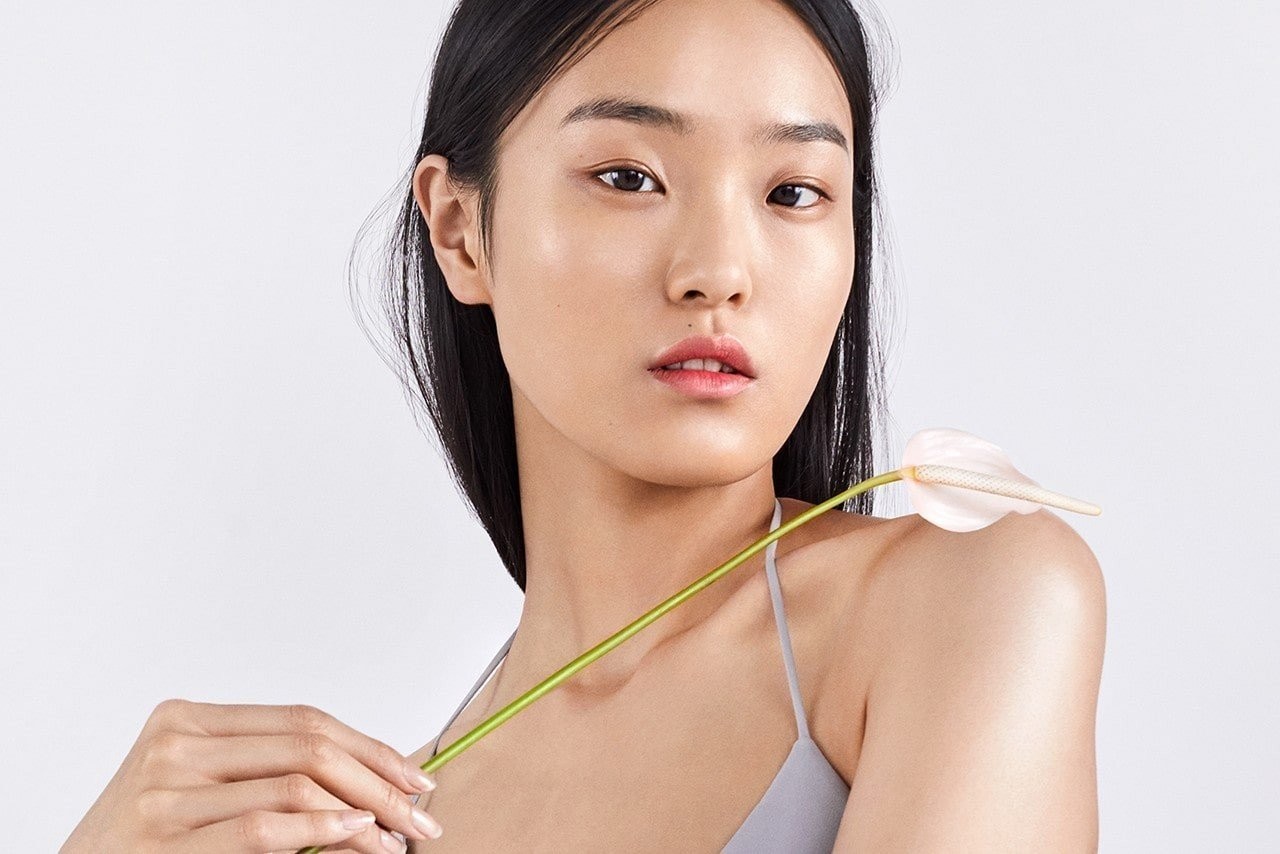 korean-model-posing-holding-a-flower-over-her-shoulder.jpg