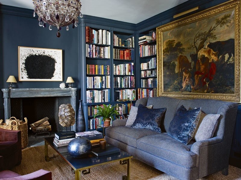 aerin-lauder-home-apartment-new-york-living-room-navy-blue-sofa-bookcases-charcoal-navy-paint-walls-log-basket.jpg