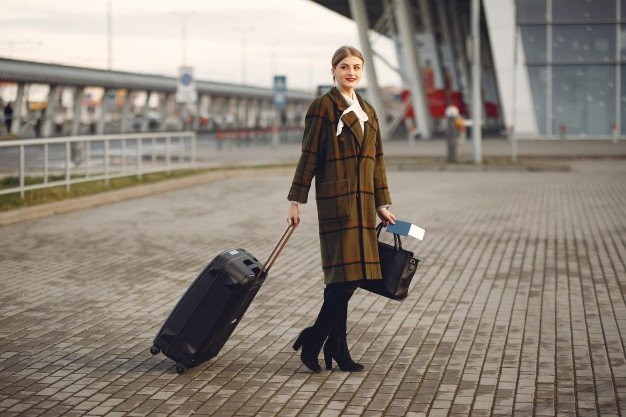 woman-with-suitcase-standing-by-airport-1157-33527.jpg