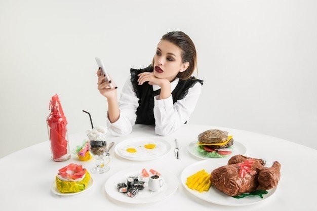we-are-what-we-eat-woman-s-using-smartphone-against-dishes-made-plastic-eco-concept-ketchup-sushi-fried-chicken-burger-environmental-disaster-fashion-beauty-food-loosing-organic-world-155003-37800.jpg